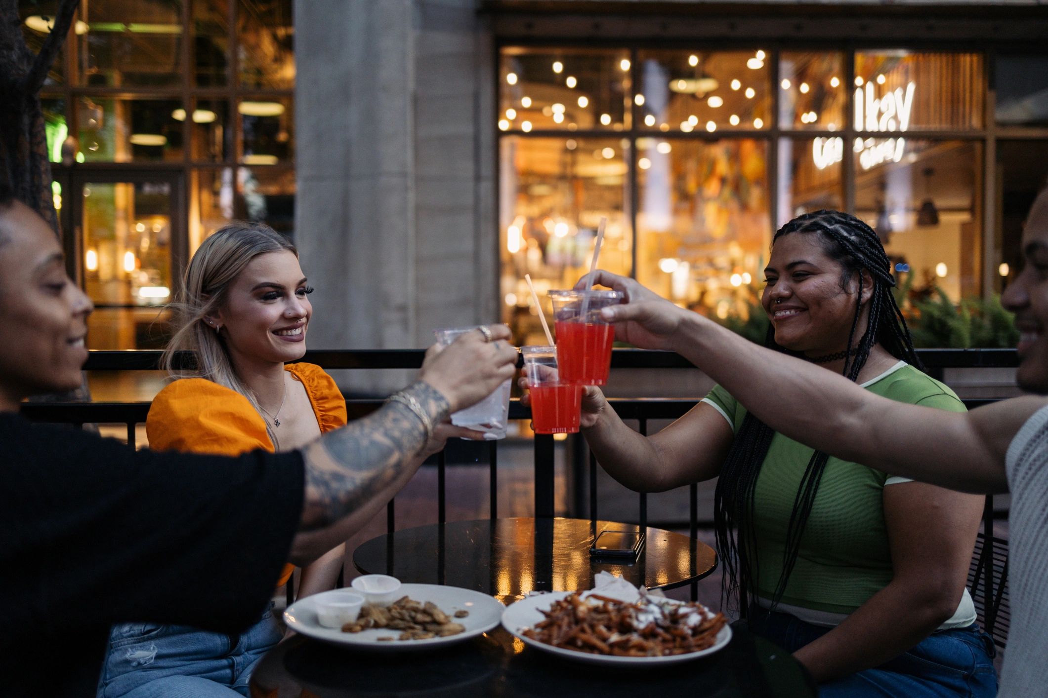 Friends toasting at an outdoor restaurant